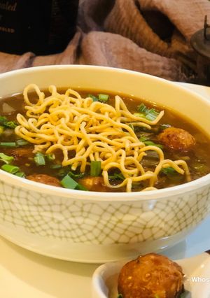 A picture of Whosayna’s Chicken Manchow Soup topped with Manchurian balls.