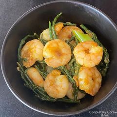 A picture of King Prawns with samphire & lemon butter glaze.