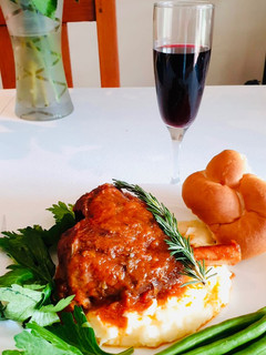 A picture of Lamb shank and veg with family.