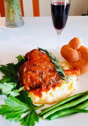 A picture of Lamb shank and veg with family.