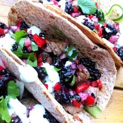 A picture of Lamb tacos with blackberry salsa and mint /chives yoghurt sauce.