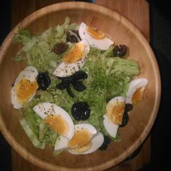 A picture of Raw salad with half boiled eggs.