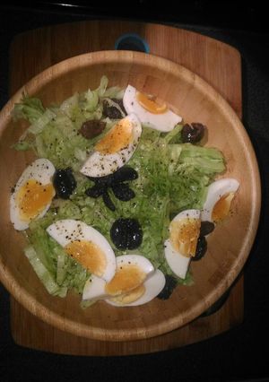 A picture of Raw salad with half boiled eggs.