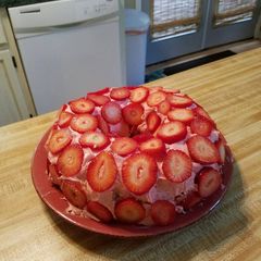 A picture of Strawberry cake with Fresh Strawberries.