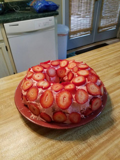 A picture of Strawberry cake with Fresh Strawberries.