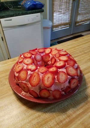 A picture of Strawberry cake with Fresh Strawberries.