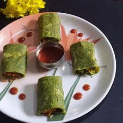 A picture of Coriander chilla roll up.