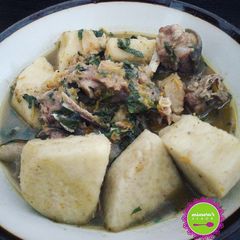 A picture of Goat meat, stock fish and yam pepper soup.