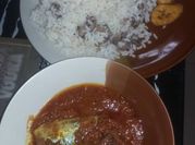 A picture of boiled rice and tomato stew