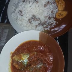 A picture of Titus fish stew with boiled rice and beans.