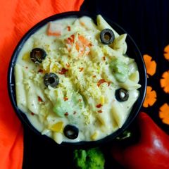 A picture of Cheesy and Creamy veggie white sauce penne pasta (with fresh cream, cheese and seasonings).