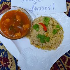 A picture of Chicken chilli gravy with fried rice.