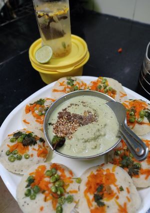 A picture of Oats mixed idli batter vegetables Idli Chutney.