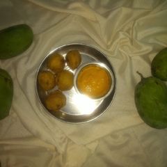 A picture of Aloo vada with mango juice.