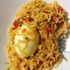 A picture of Jollof noodles and egg.