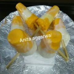 A picture of Indian frozen dessert mango bar(popsicle) with curd.