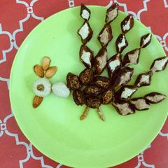 A picture of Dryfruits sweet in Peacock pattern.