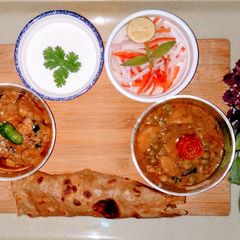 A picture of Alo matar ki bhujiya and masalaydar chicken.