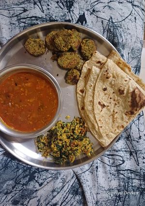 A picture of Maharashtrian simple thali with walach birde.