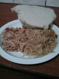 A picture of Fried eggs served with fried cabbage and ugali.