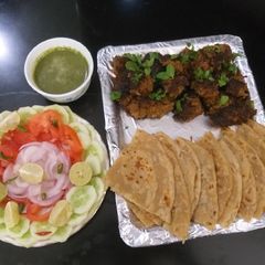 A picture of Mutton kababs and parathas with curd chattny and salad.