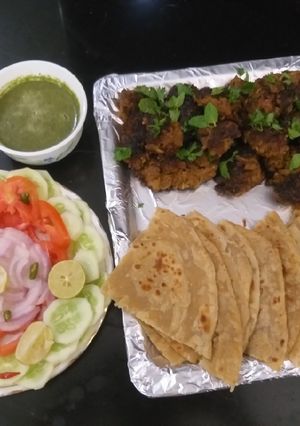 A picture of Mutton kababs and parathas with curd chattny and salad.