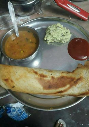 A picture of Sambhar dosa with coconut chtni and sauce.