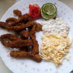 A picture of Simple fish fingers with tartar sauce and coleslaw.