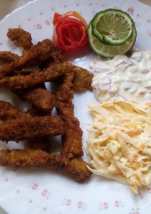 A picture of Simple fish fingers with tartar sauce and coleslaw.