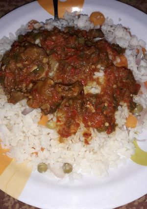 A picture of White rice and source with vegetables.