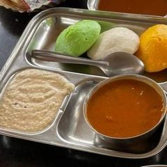 A picture of Tri color idli sambhar with chutney.