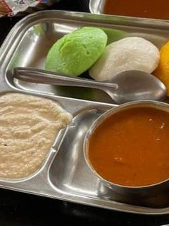 A picture of Tri color idli sambhar with chutney.