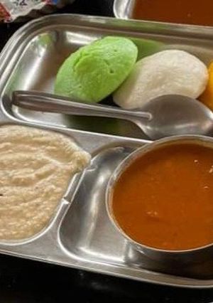 A picture of Tri color idli sambhar with chutney.