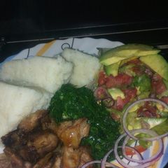 A picture of Goat roasted meat, greens and lettuce kachumbari.