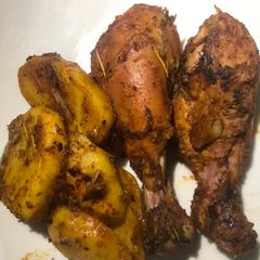 A picture of Grilled chicken drums and potatoes.