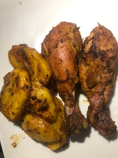 A picture of Grilled chicken drums and potatoes.