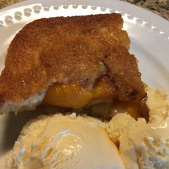 A picture of Peach Cobbler with BlueBell Homemade Vanilla Ice Cream.