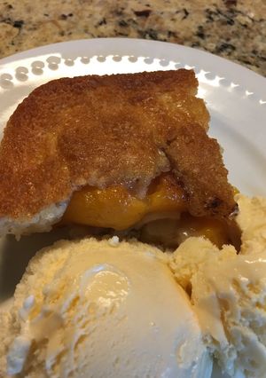 A picture of Peach Cobbler with BlueBell Homemade Vanilla Ice Cream.