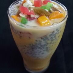 A picture of Mango shake with sabja.