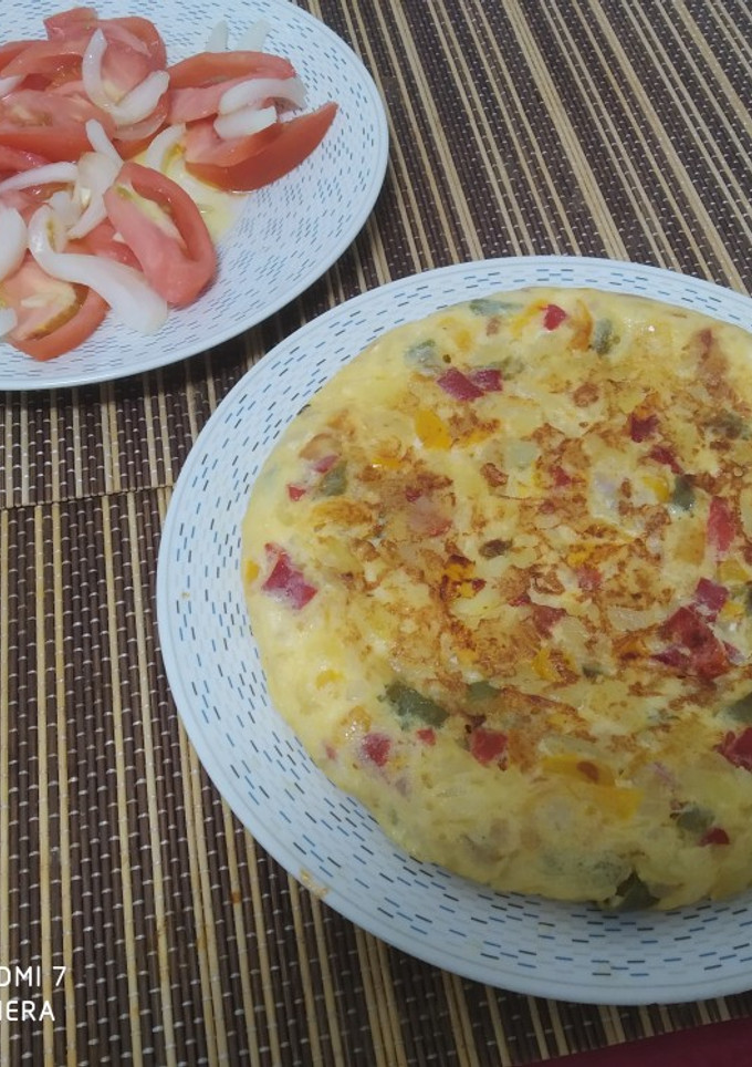 Una foto de Tortilla de pimientos, cebolla, y patata,