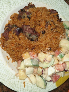 A picture of Party Jallof rice nd cucumber salad.