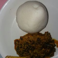 A picture of Egusi soup and tuwon shinkafa.