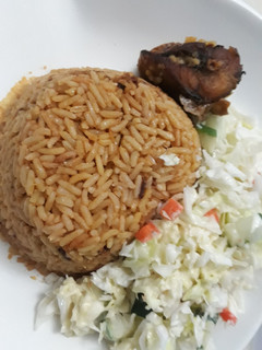 A picture of Jollof rice and coslaw.