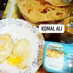 A picture of Half fry Egg paratha and tea.