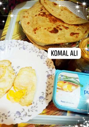 A picture of Half fry Egg paratha and tea.