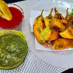 Mirchi vada with coriander chutney A picture of Mirchi vada with coriander chutney.