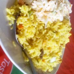 A picture of Fried rice with coleslaw.
