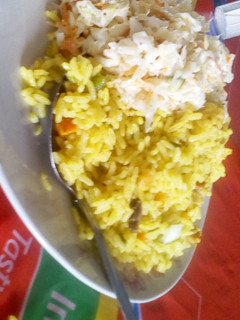 A picture of Fried rice with coleslaw.