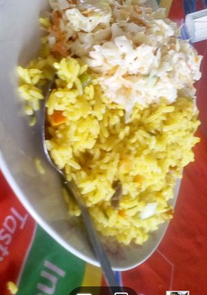 A picture of Fried rice with coleslaw.