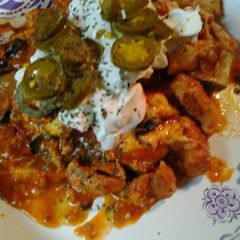 A picture of Chicken in a zucchini boat.